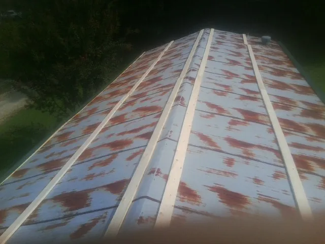 Rusted metal roof panels with new wood purlins before replacement — Storm Damage Roof Repair in Winter Haven by Roofing Brothers